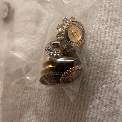 A VARIETY OF PINS AND BUTTONS