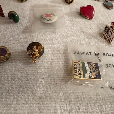 A VARIETY OF PINS AND BUTTONS