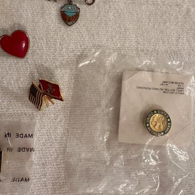 A VARIETY OF PINS AND BUTTONS