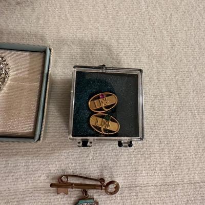 A VARIETY OF PINS AND BUTTONS