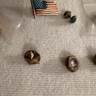 A VARIETY OF PINS AND BUTTONS