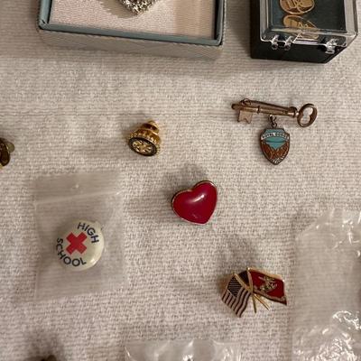 A VARIETY OF PINS AND BUTTONS