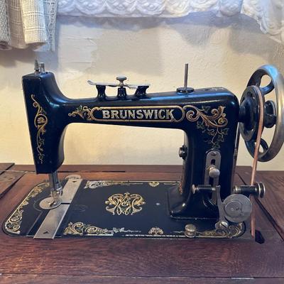 BRUNSWICK TREADLE SEWING MACHINE IN CABINET