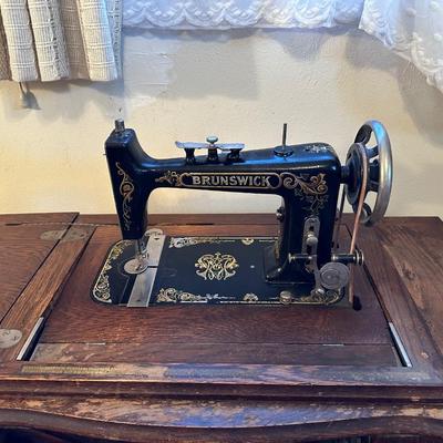 BRUNSWICK TREADLE SEWING MACHINE IN CABINET