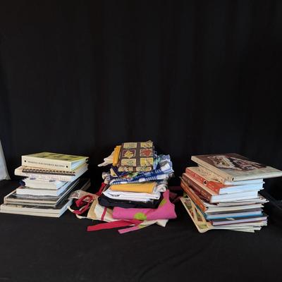 Several Cookbooks, Tea Towels, and Aprons (LR-DZ)