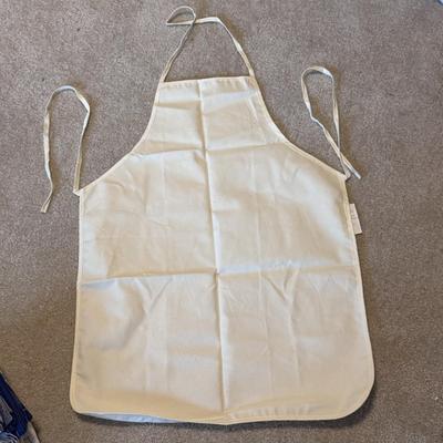 Several Cookbooks, Tea Towels, and Aprons (LR-DZ)