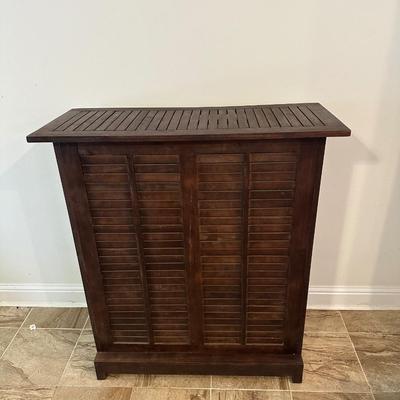 Sale Photo Thumbnail #4: Compact wooden bar cabinet with slatted sides and back, three open shelves, and a bottom rack with slots for storing up to 6 bottles. 

Dimensions: 43.5” tall x 39.5” wide x 16.5” deep