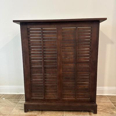 Sale Photo Thumbnail #5: Compact wooden bar cabinet with slatted sides and back, three open shelves, and a bottom rack with slots for storing up to 6 bottles. 

Dimensions: 43.5” tall x 39.5” wide x 16.5” deep