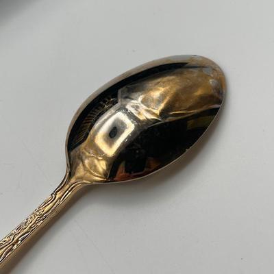 Sale Photo Thumbnail #45: This vintage flatware set by WM Rogers features a warm gold-toned finish and classic design. Some pieces show fading and wear consistent with age and use—please refer to photos for condition details.