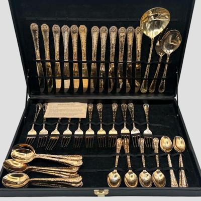 Sale Photo Thumbnail #42: This vintage flatware set by WM Rogers features a warm gold-toned finish and classic design. Some pieces show fading and wear consistent with age and use—please refer to photos for condition details.