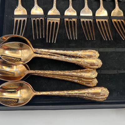 Sale Photo Thumbnail #47: This vintage flatware set by WM Rogers features a warm gold-toned finish and classic design. Some pieces show fading and wear consistent with age and use—please refer to photos for condition details.