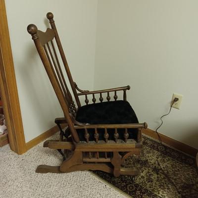 ANTIQUE GLIDER ON CASTERS WITH A VELVET COVERED SEAT