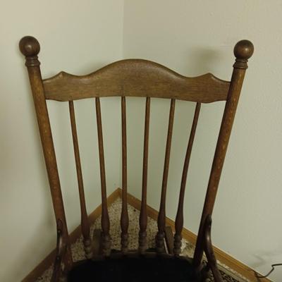 ANTIQUE GLIDER ON CASTERS WITH A VELVET COVERED SEAT