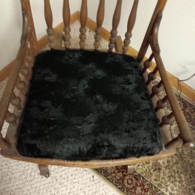 ANTIQUE GLIDER ON CASTERS WITH A VELVET COVERED SEAT