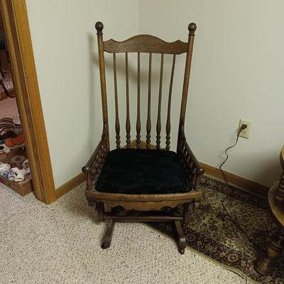 ANTIQUE GLIDER ON CASTERS WITH A VELVET COVERED SEAT