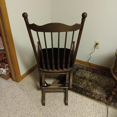 ANTIQUE GLIDER ON CASTERS WITH A VELVET COVERED SEAT