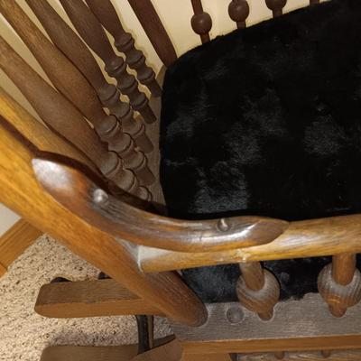 ANTIQUE GLIDER ON CASTERS WITH A VELVET COVERED SEAT