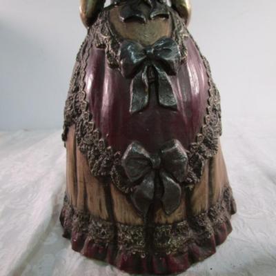 2 statuettes, 1 is mom with 2 kids, 1 Victorian woman