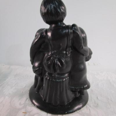 2 statuettes, 1 is mom with 2 kids, 1 Victorian woman