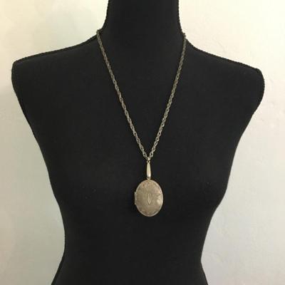 Antique locket necklace has a lot of wear