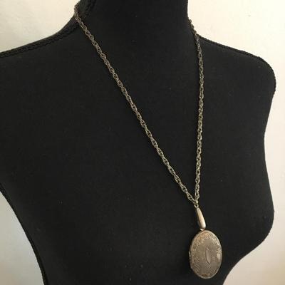 Antique locket necklace has a lot of wear