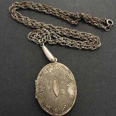 Antique locket necklace has a lot of wear