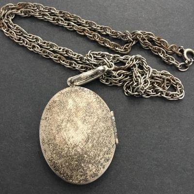 Antique locket necklace has a lot of wear
