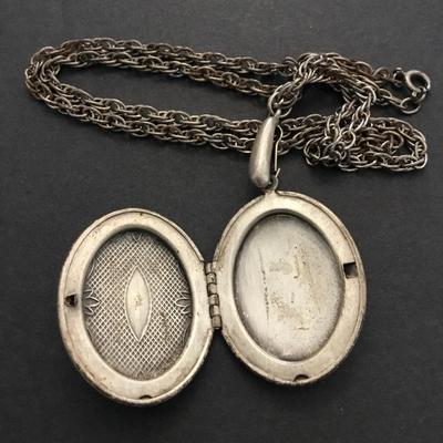 Antique locket necklace has a lot of wear