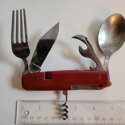 Sale Photo Thumbnail #281: This auction lot is for a Field Gear Dining/Kitchen Knife.  This Knife has a blade, a fork, a spoon, a can/bottle opener and a corkscrew.  Almost a cutlery drawer in a folding knife,  Ready for your next big hike or camp out.  See photos for sizing.
