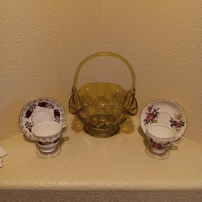 YELLOW GLASS BASKET AND 2 TEA CUPS AND SAUCER SETS