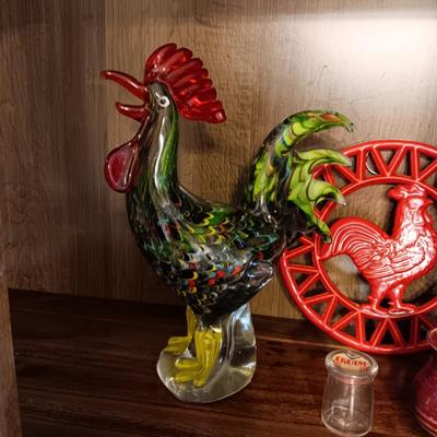 MULTI COLORED GLASS ROOSTER, CAST IRON TRIVET, CLAY EGG SEPARATOR & GLASS CREAM CONTAINER