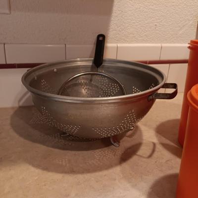 LARGE PYREX BOWL, METAL STRAINERS AND TUPPERWARE CANISTERS