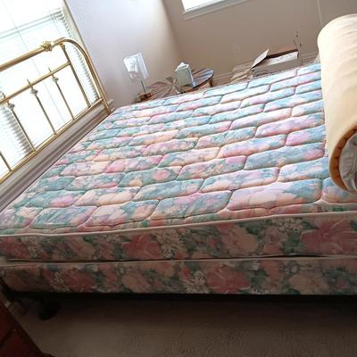 QUEEN SIZE BED W/DOWN FILLED MATTRESS TOPPER, ALL THE BEDDING, BRASS COLORED HEADBOARD AND FRAME ON CASTERS