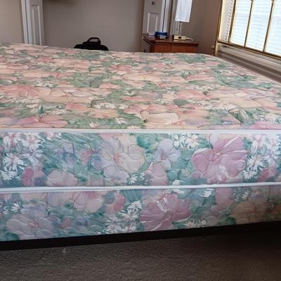 QUEEN SIZE BED W/DOWN FILLED MATTRESS TOPPER, ALL THE BEDDING, BRASS COLORED HEADBOARD AND FRAME ON CASTERS