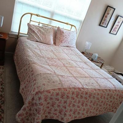 QUEEN SIZE BED W/DOWN FILLED MATTRESS TOPPER, ALL THE BEDDING, BRASS COLORED HEADBOARD AND FRAME ON CASTERS