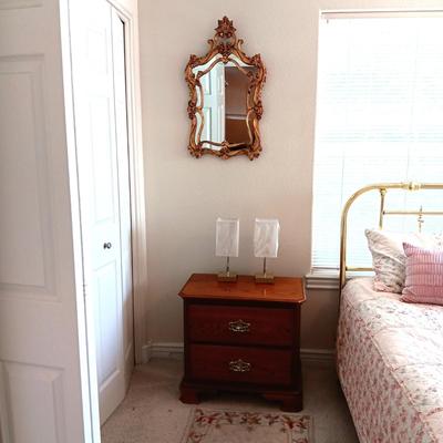 2 DRAWER NIGHT STAND, 2 SMALL LAMPS AND A GOLD FRAMED WALL MIRROR