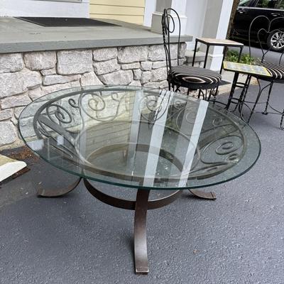 Round glass coffee table with metal stand