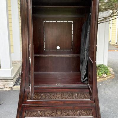 Wood armoire with floral detail