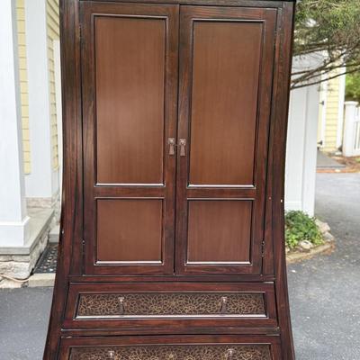 Wood armoire with floral detail