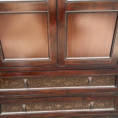 Wood armoire with floral detail