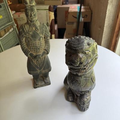 Three stone statues, foo dog, Egyptian bird and Asian soldier