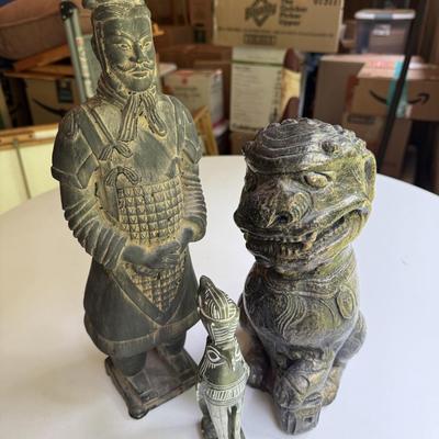 Three stone statues, foo dog, Egyptian bird and Asian soldier