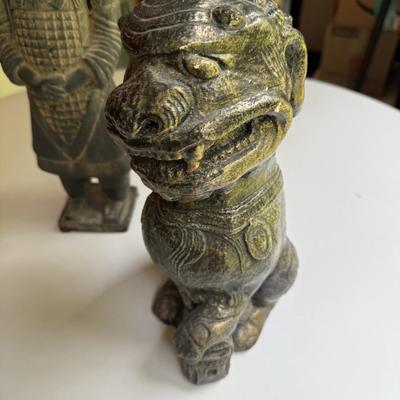Three stone statues, foo dog, Egyptian bird and Asian soldier