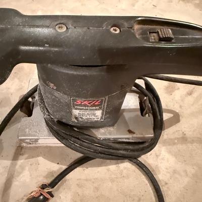 Two power hand tools, Skilsaw and Black and Decker