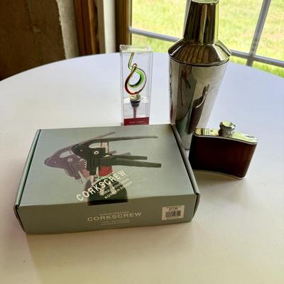 Four pieces of barware including new glass bottle stopper