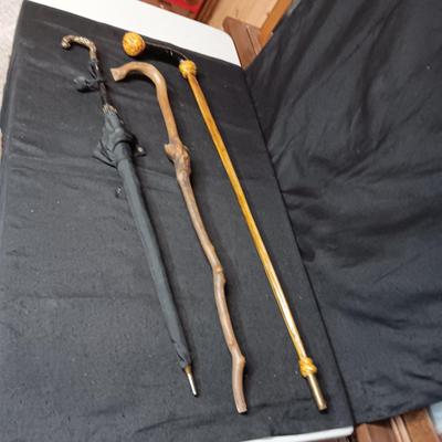 2 VINTAGE WOODEN CANES AND AN OLD UMBRELLA