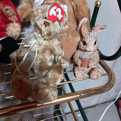 A COLLECTION OF PLUSH ANIMALS WITH A TOTE