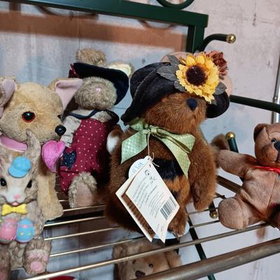 A COLLECTION OF PLUSH ANIMALS WITH A TOTE