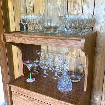 LOT 75: Cabinet / Bar with Contents and Large Collection of Glasses, Decanters, Pitchers and More