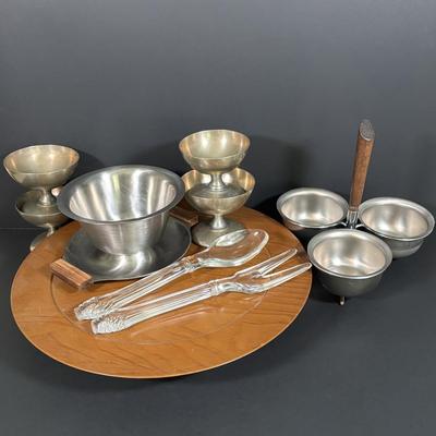 LOT 133: MCM Wooed Lazy Susan, Stainless Steel Condiment Server, Gravy Boat, 4 Silver Plated Dessert Cups and Glass Salad Serving Spoon...
